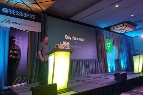 Seth Carstens speaking on stage at PressNomics